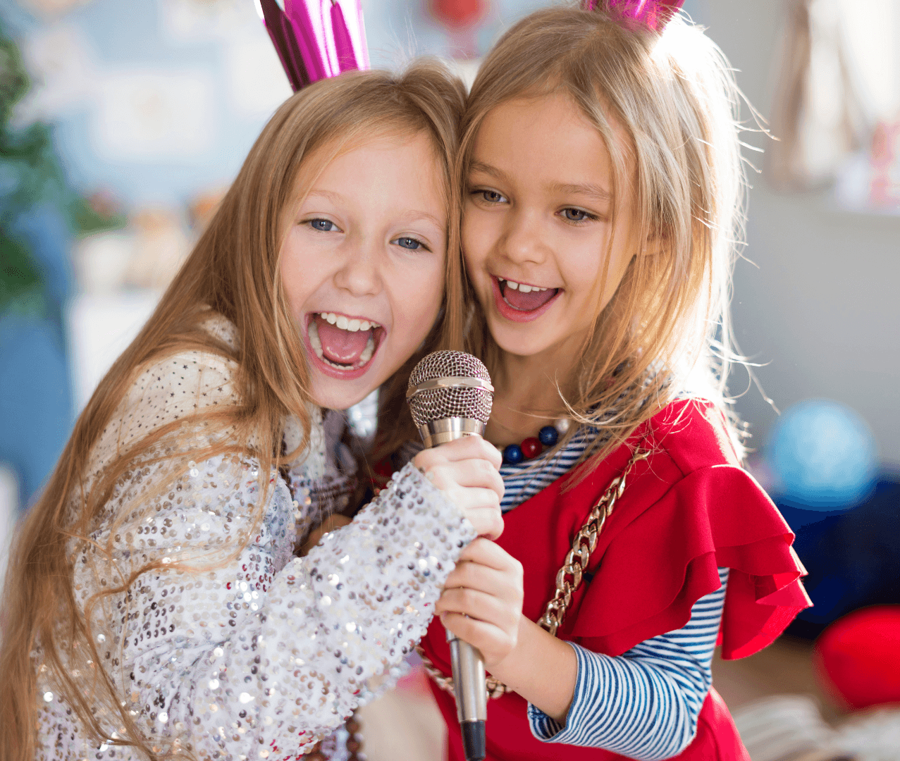Two kids sharing a microphone and singing together.