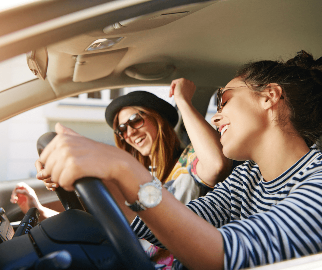 Two friends singing together during a road trip.
